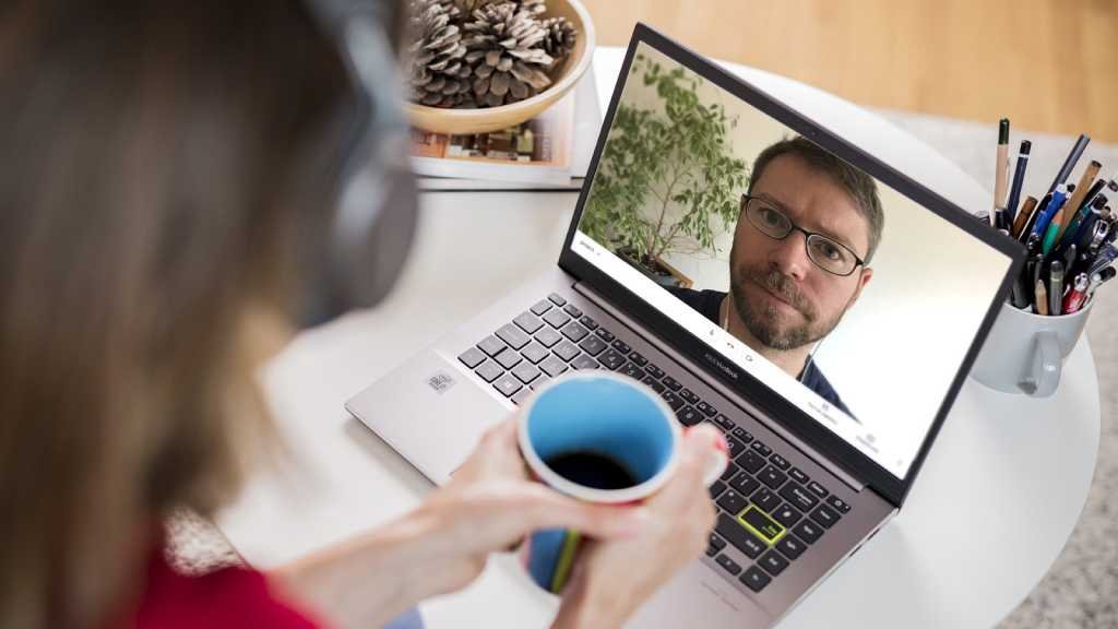 A woman making an online video call to a man