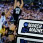 March Madness sign in front of basketball players